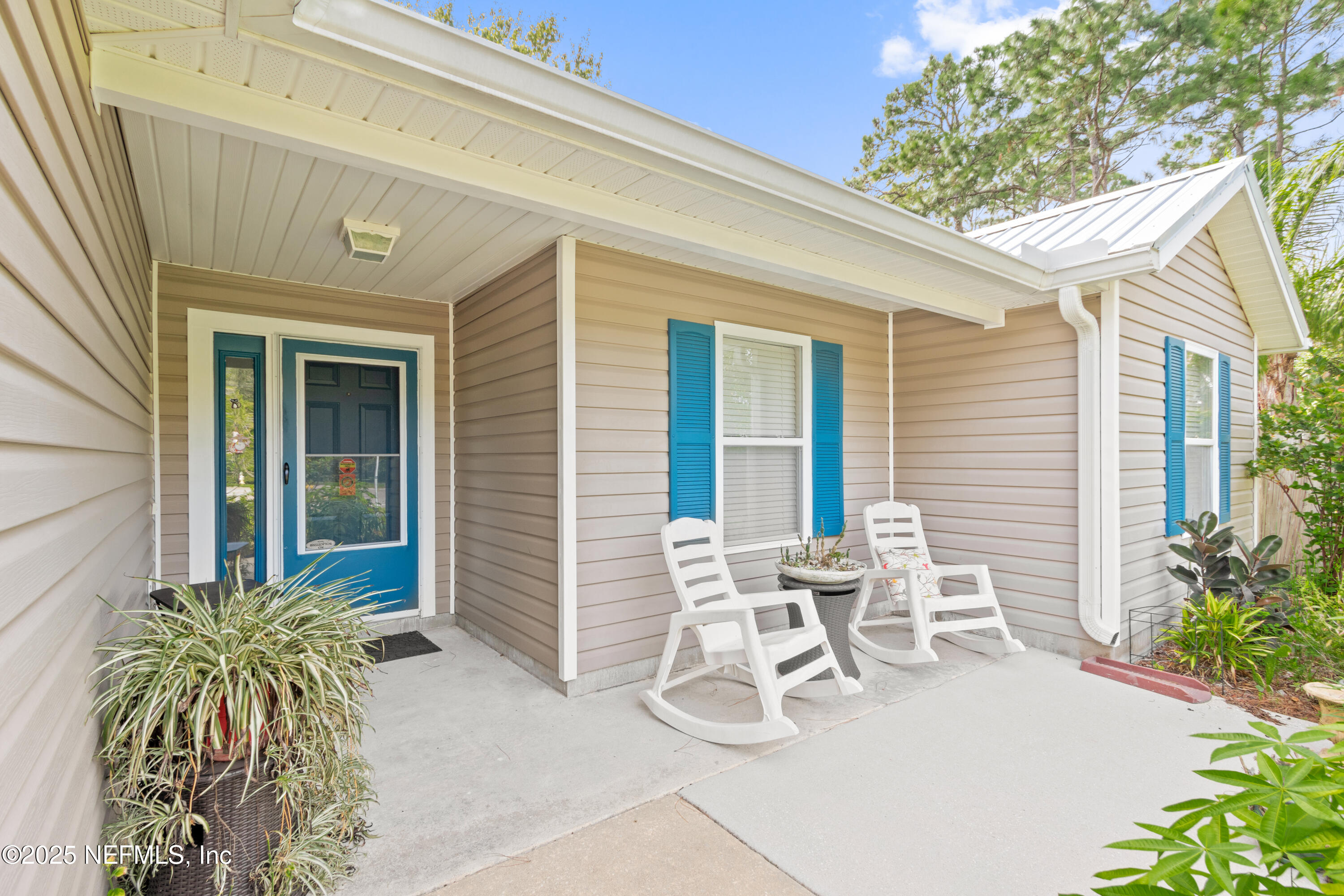 1193 4 Mile Road St. Augustine, FL 32084 - Photo 3 of 54 a view of a patio with table and chairs and potted plants