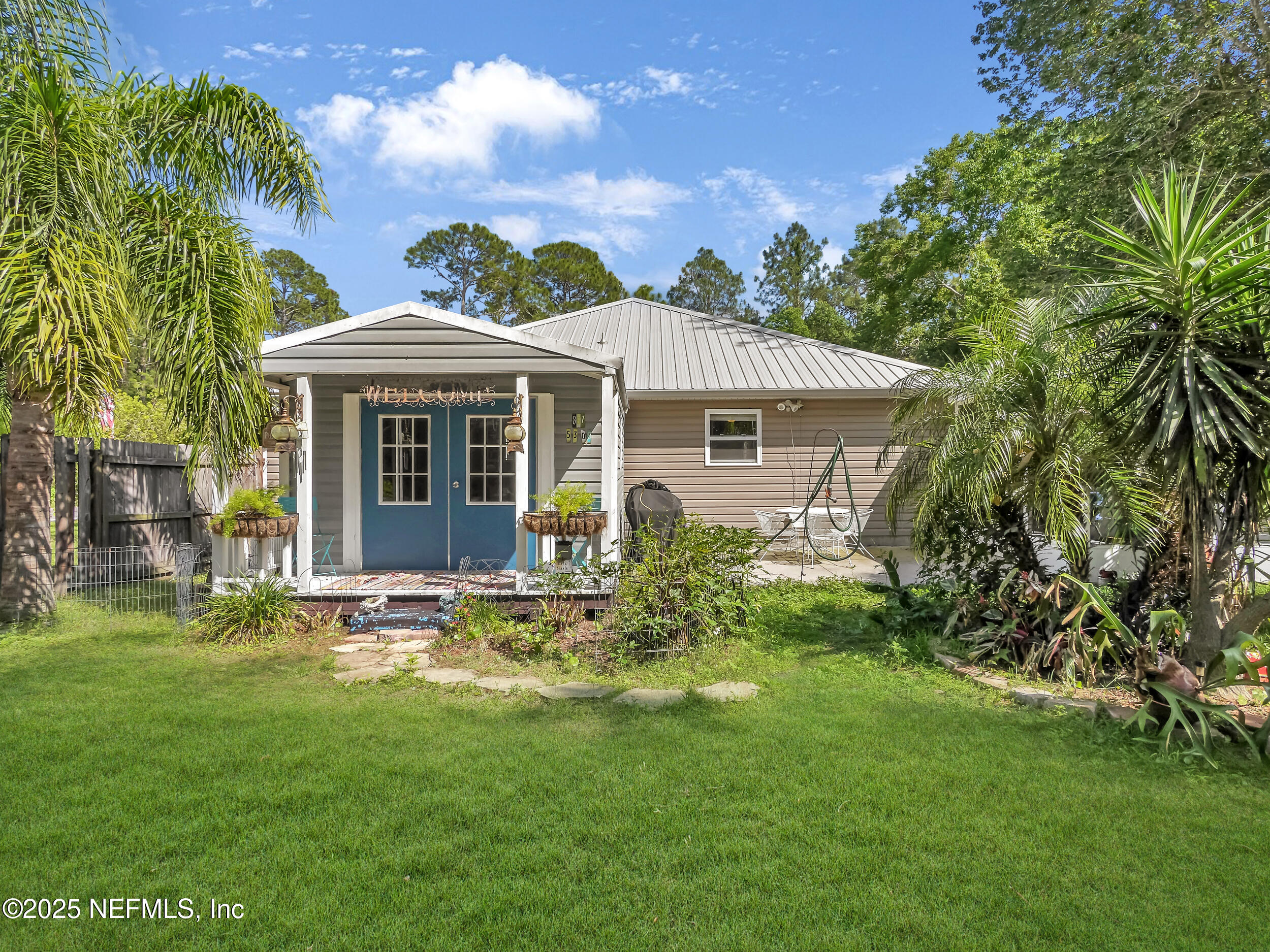 1193 4 Mile Road St. Augustine, FL 32084 - Photo 32 of 54 a front view of a house with a garden