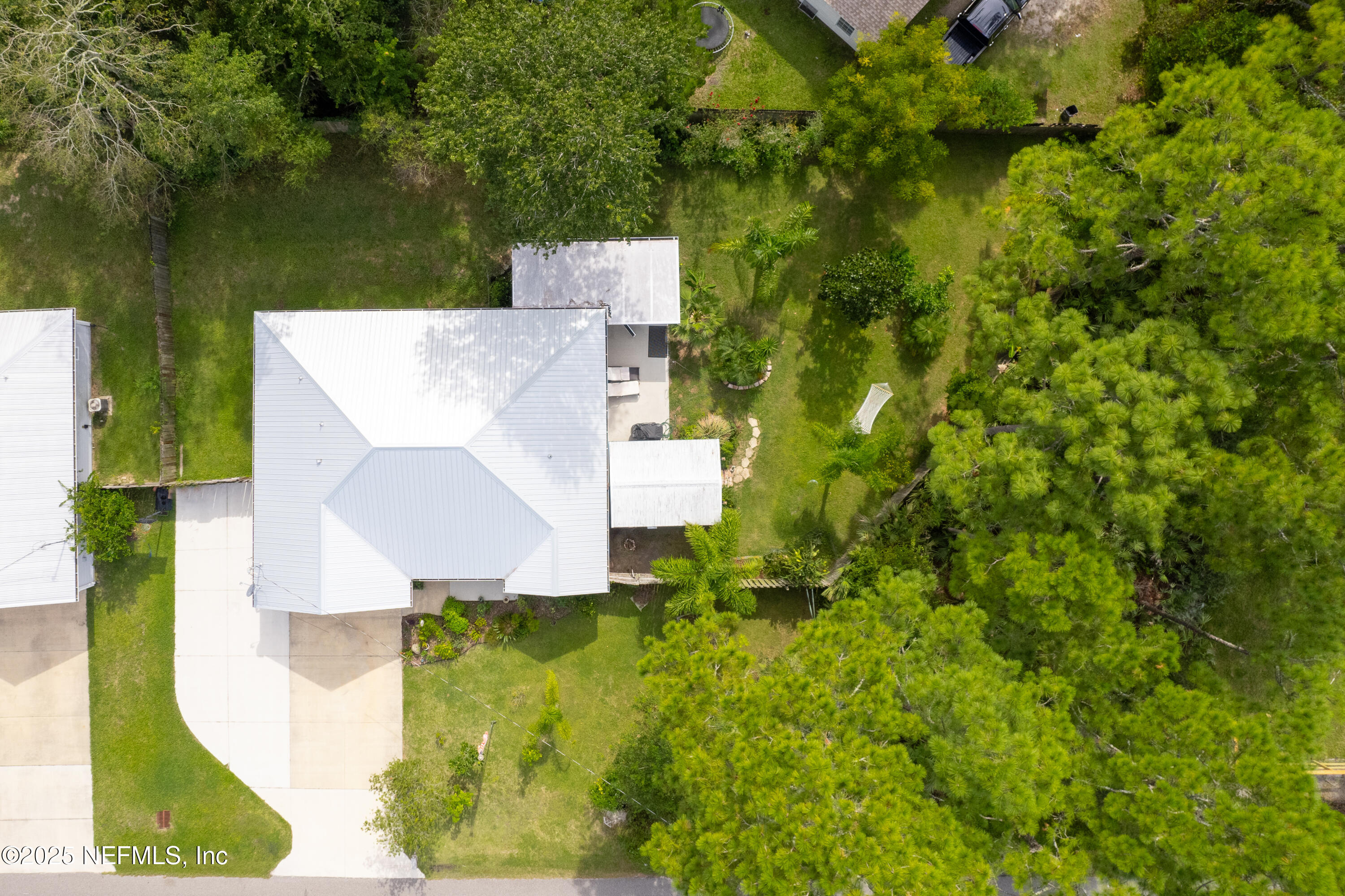 1193 4 Mile Road St. Augustine, FL 32084 - Photo 45 of 54 an aerial view of a house with a yard and lake view