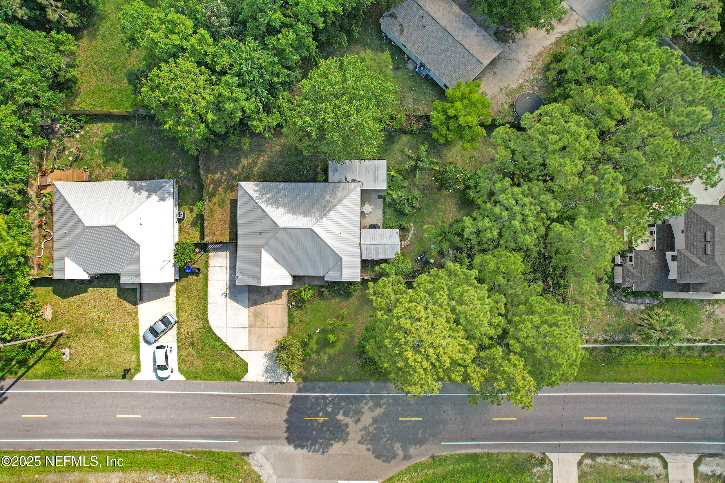 1193 4 Mile Road St. Augustine, FL 32084 - Photo 48 of 54 an aerial view of a house with a yard and large tree