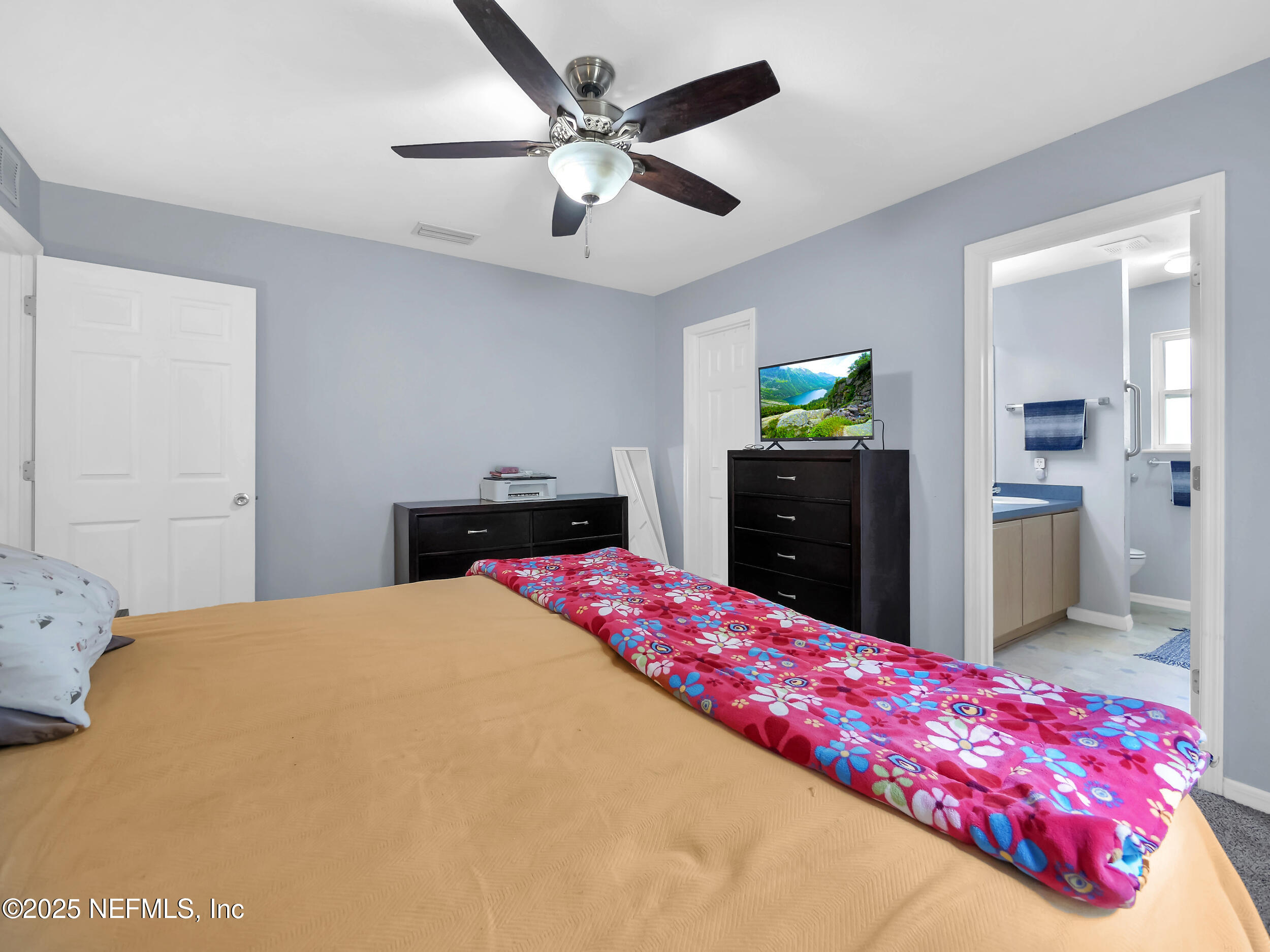 1193 4 Mile Road St. Augustine, FL 32084 - Photo 9 of 54 a bedroom with a bed and a dresser