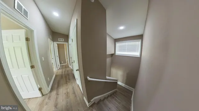 a view of a bathroom from a hallway