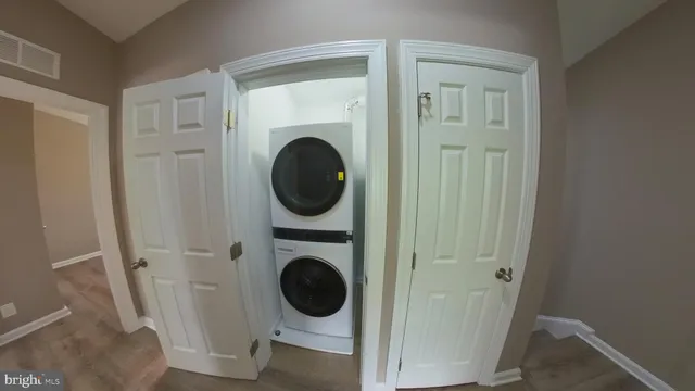a view of a hallway with washer and dryer