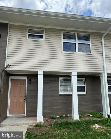 a view of a hallway with a room and a bathroom