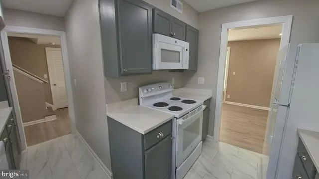a kitchen with a refrigerator sink and stove