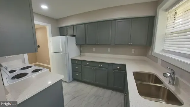 a kitchen with a refrigerator and a sink