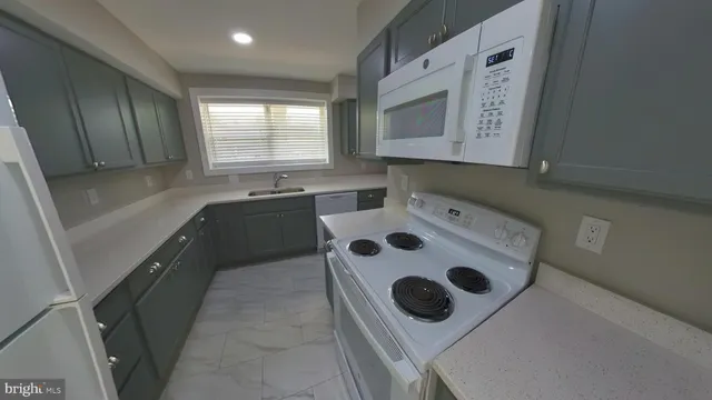 a kitchen with a sink stove and refrigerator