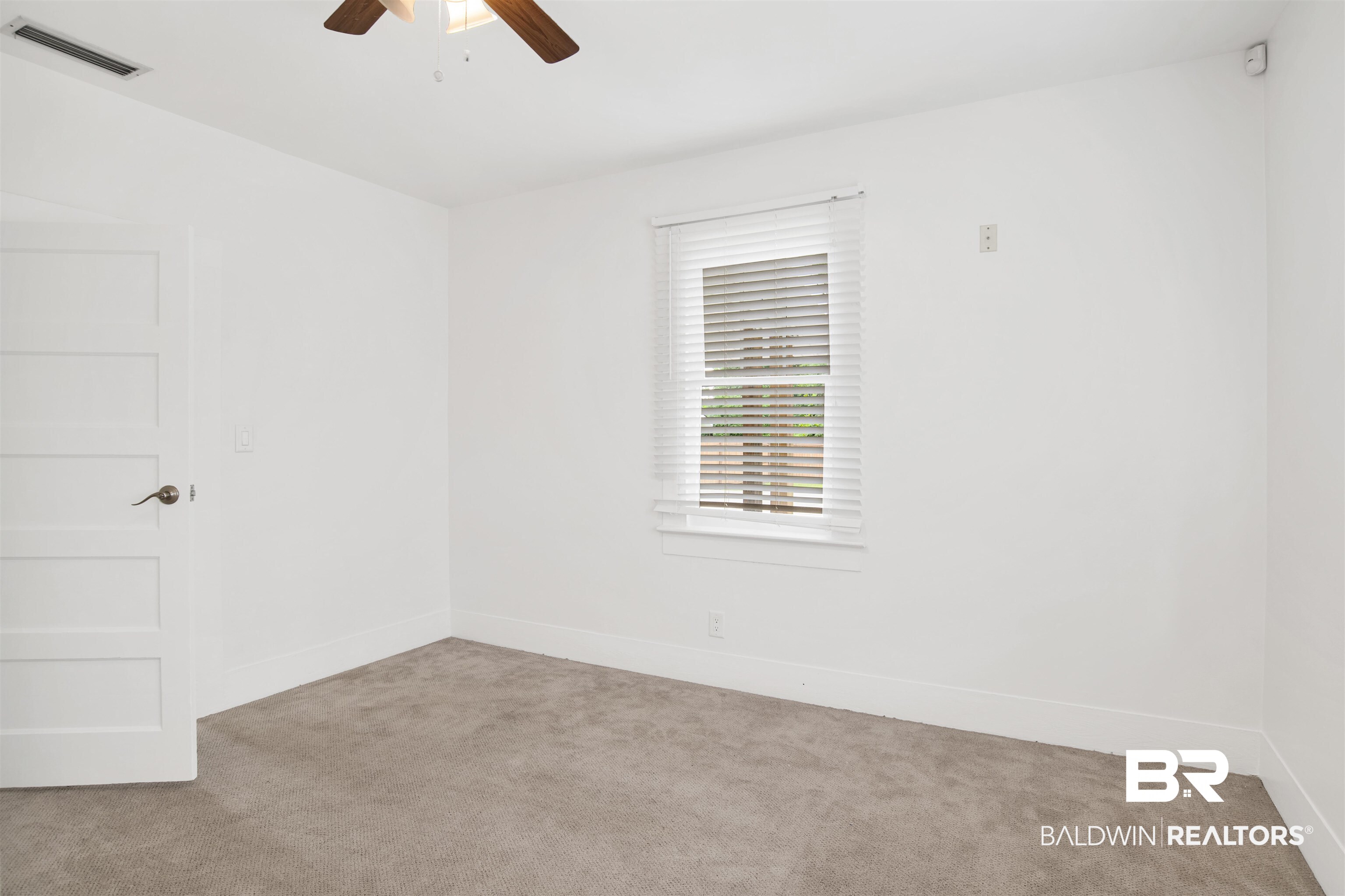 507 Holcombe Avenue Mobile, AL 36606 - Photo 26 of 28 Carpeted spare room with ceiling fan and baseboards