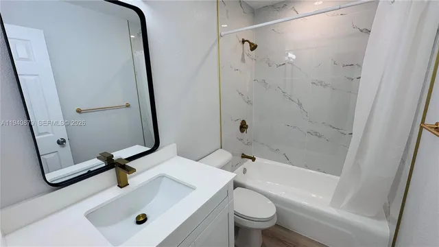 a bathroom with a sink a toilet and a tub