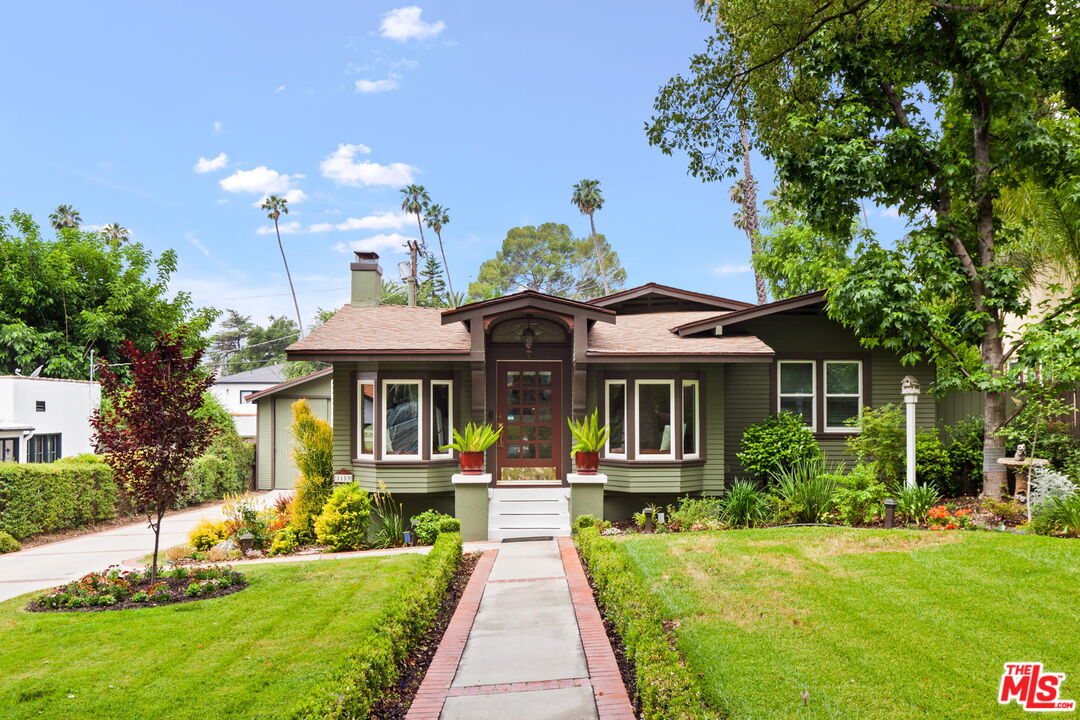 a front view of a house with a yard table and chairs