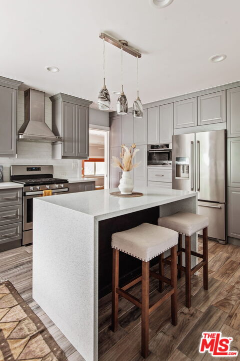 5159 Shearin Avenue Los Angeles, CA 90041 - Photo 20 of 47 a kitchen with granite countertop a table chairs stove and refrigerator