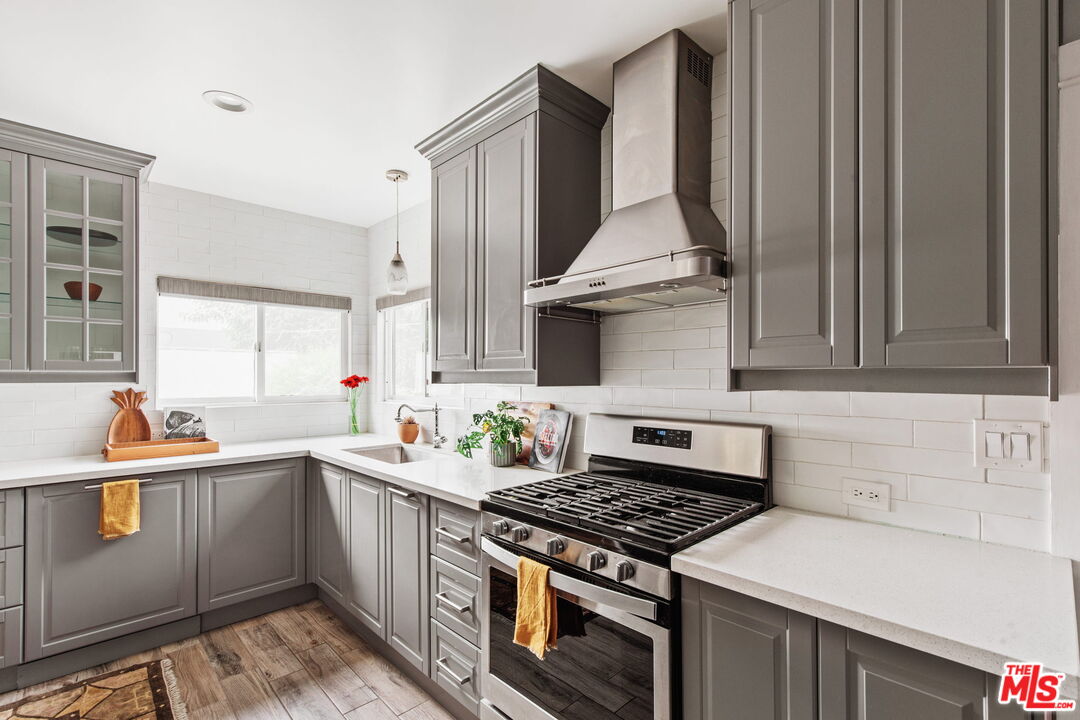5159 Shearin Avenue Los Angeles, CA 90041 - Photo 22 of 47 a kitchen with stainless steel appliances a stove a sink and a microwave