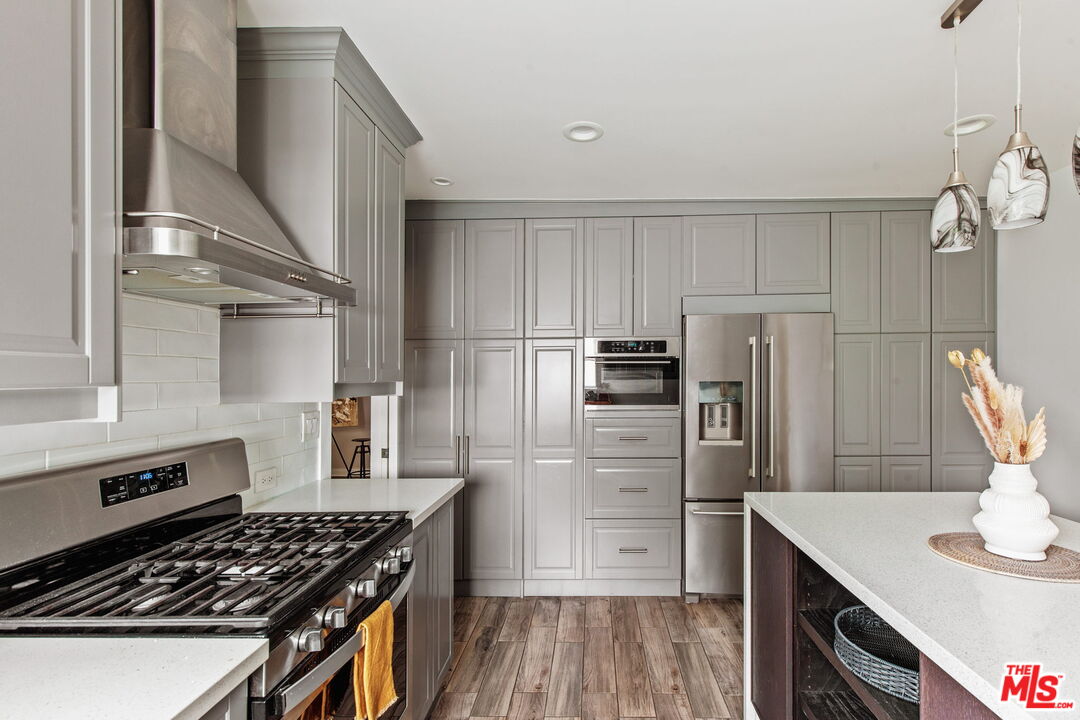 5159 Shearin Avenue Los Angeles, CA 90041 - Photo 23 of 47 a kitchen with stainless steel appliances a refrigerator and a stove top oven