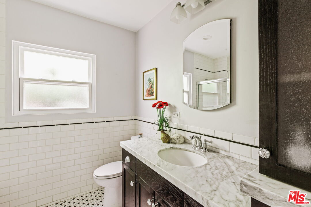 5159 Shearin Avenue Los Angeles, CA 90041 - Photo 36 of 47 a bathroom with a granite countertop sink a toilet and mirror