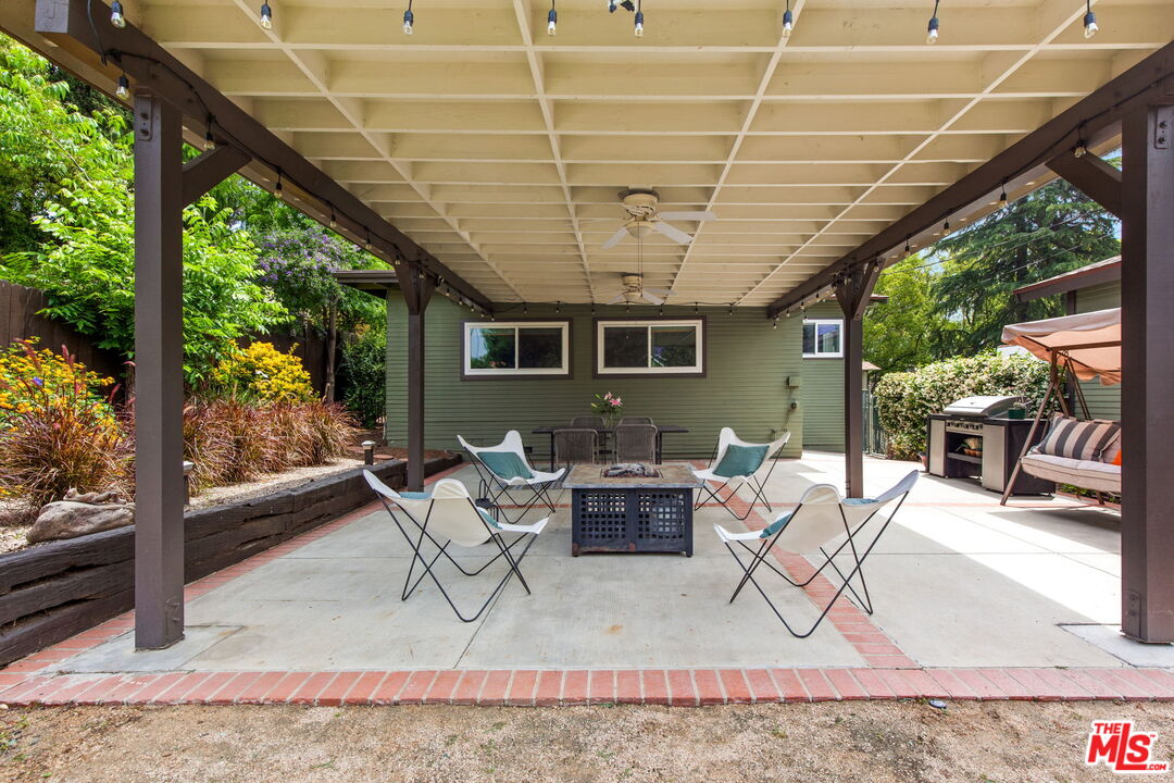 5159 Shearin Avenue Los Angeles, CA 90041 - Photo 40 of 47 a view of a patio with a table and chairs