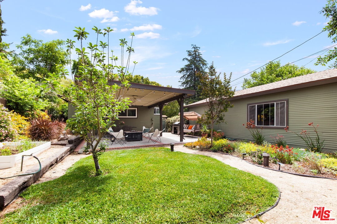 5159 Shearin Avenue Los Angeles, CA 90041 - Photo 43 of 47 a backyard of a house with table and chairs