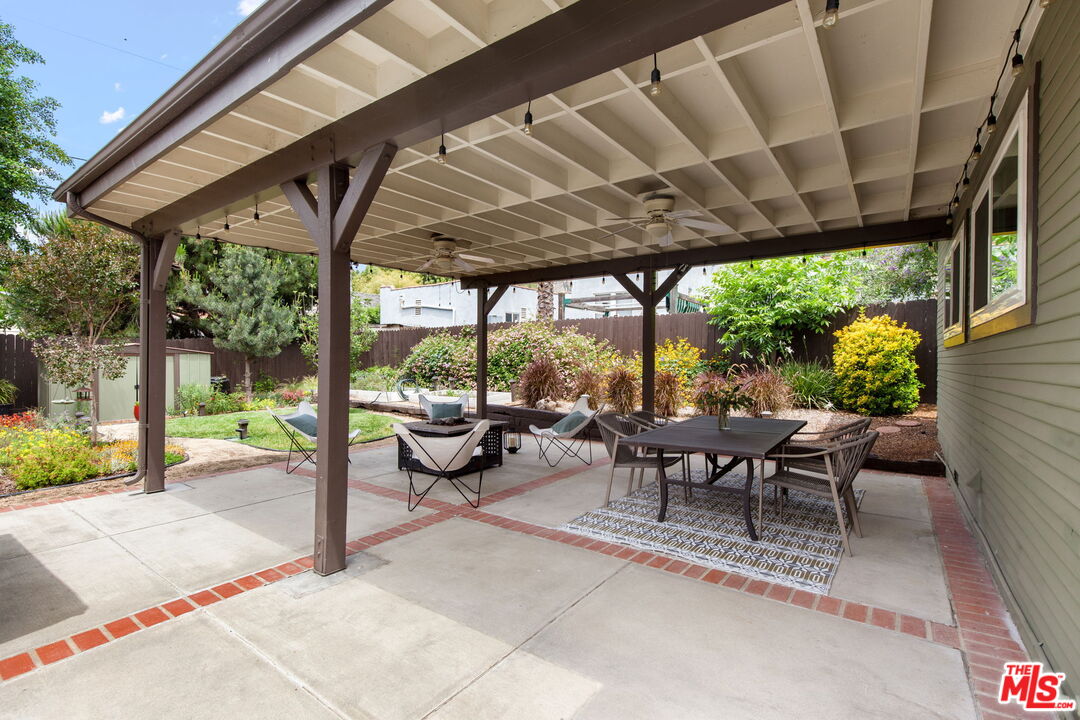 5159 Shearin Avenue Los Angeles, CA 90041 - Photo 45 of 47 a view of a patio with a table and chairs under a large umbrella