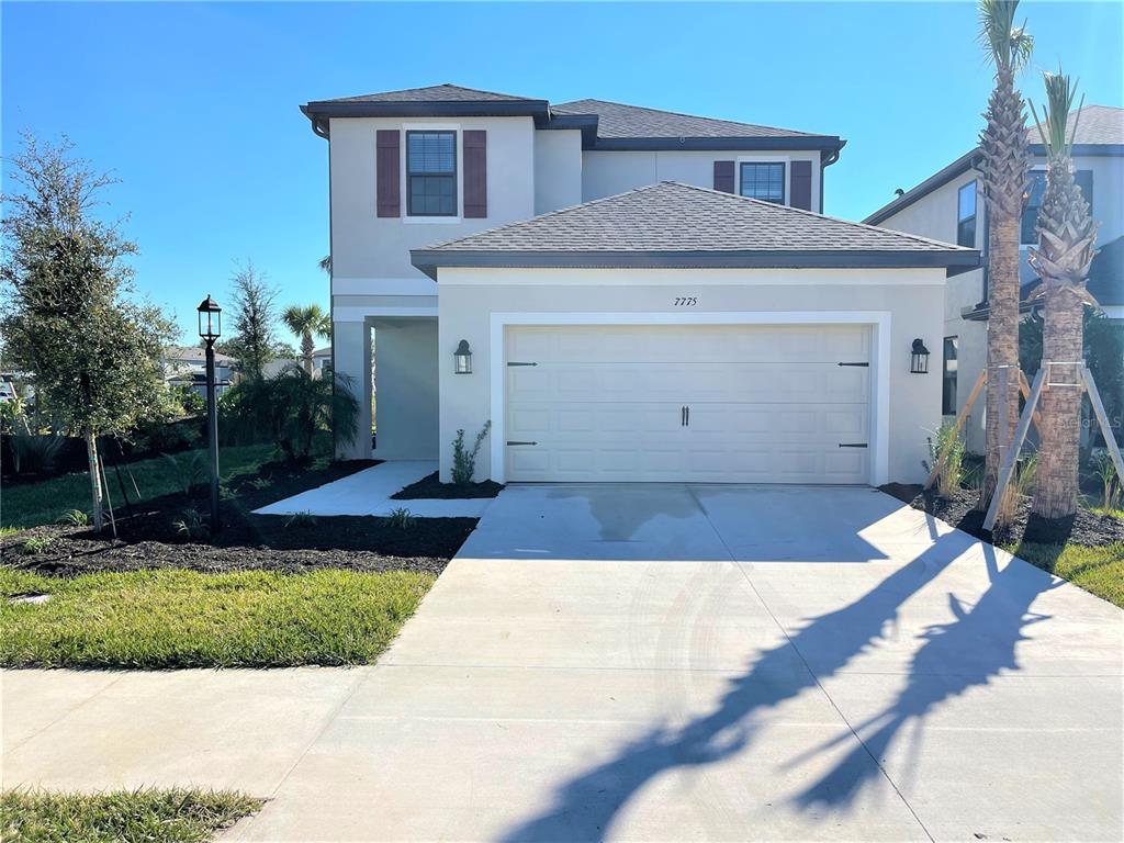 7775 Nightfall Terrace Sarasota, FL 34241 - Photo 1 of 36 a front view of a house with a yard
