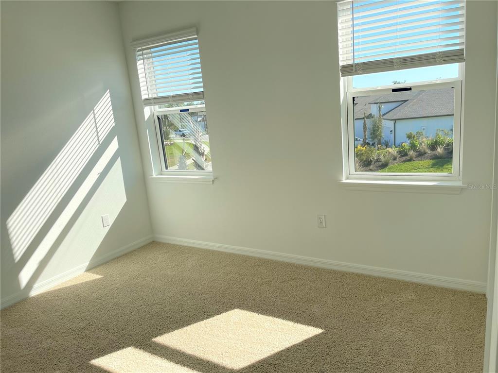 7775 Nightfall Terrace Sarasota, FL 34241 - Photo 12 of 36 an empty room with windows and closet