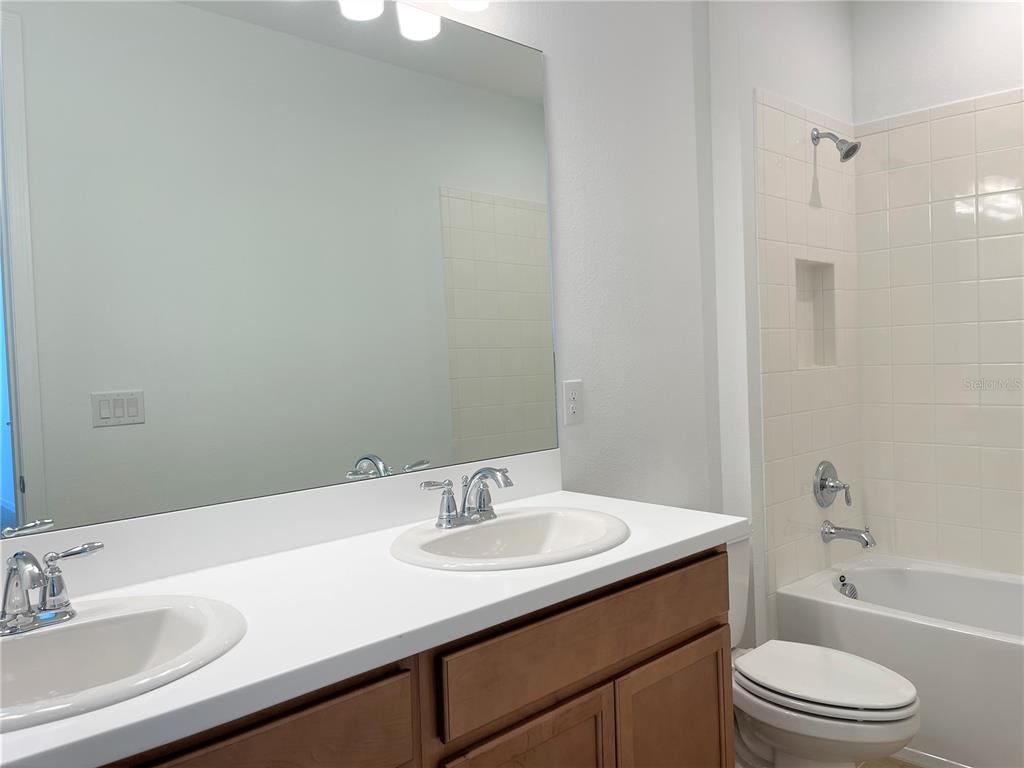 7775 Nightfall Terrace Sarasota, FL 34241 - Photo 20 of 36 a bathroom with a sink toilet a mirror and shower