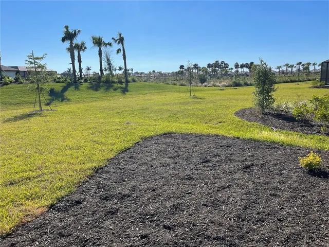 a front view of a house with a garden and yard