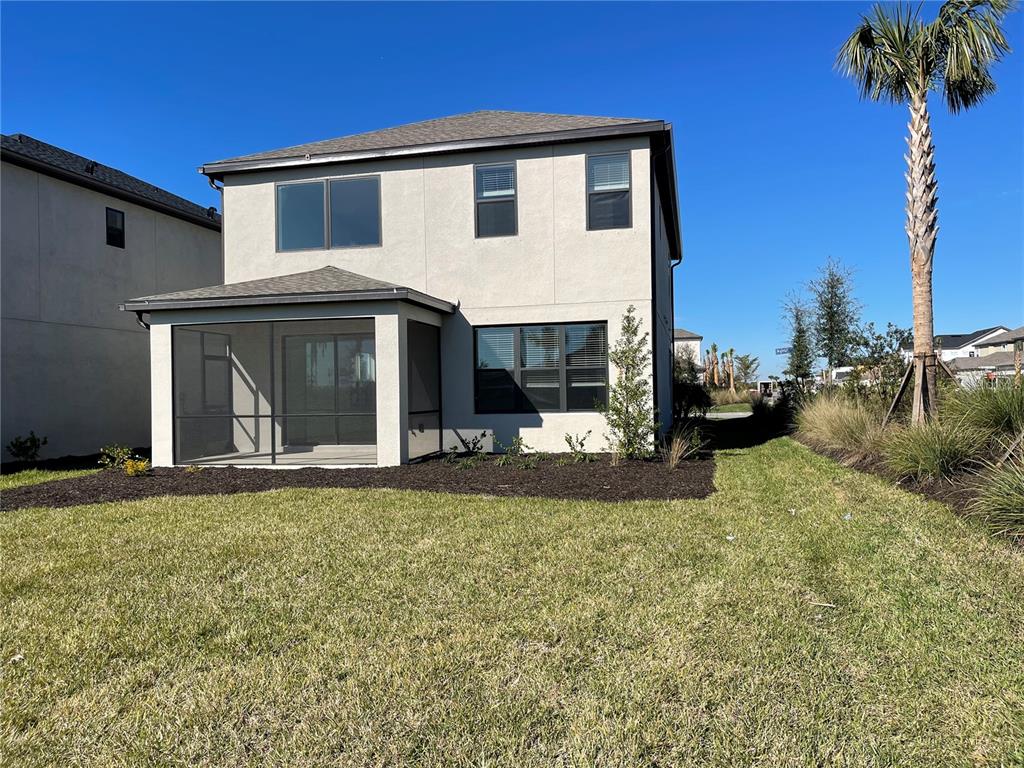 7775 Nightfall Terrace Sarasota, FL 34241 - Photo 27 of 36 a front view of a house with a garden and yard