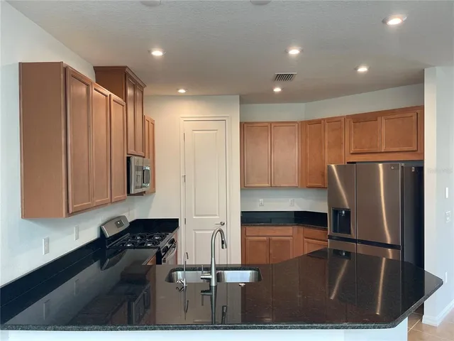 a kitchen with refrigerator and window