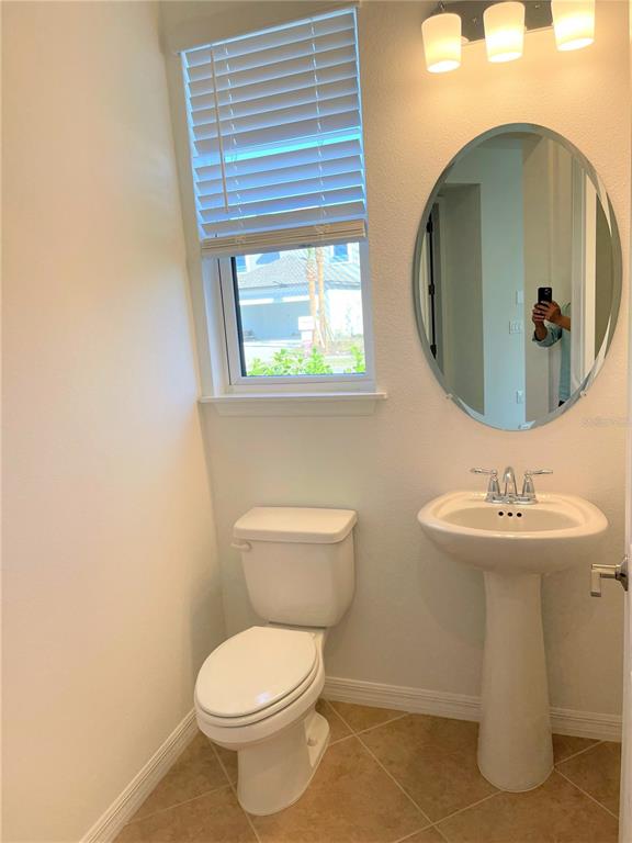 7775 Nightfall Terrace Sarasota, FL 34241 - Photo 9 of 36 a bathroom with a toilet sink and mirror