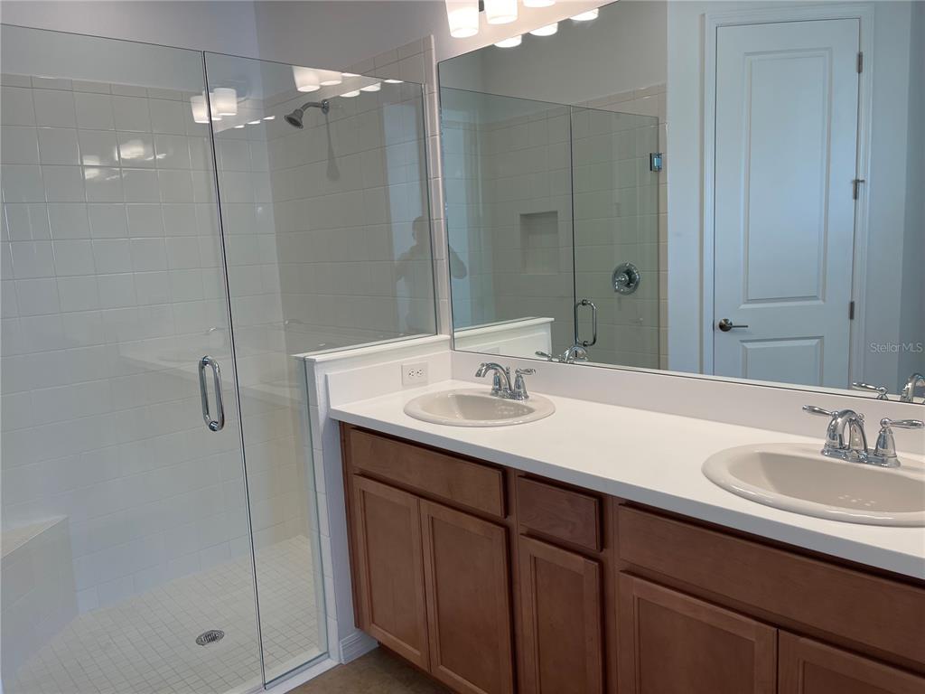 7775 Nightfall Terrace Sarasota, FL 34241 - Photo 10 of 36 a bathroom with a sink double vanity and shower