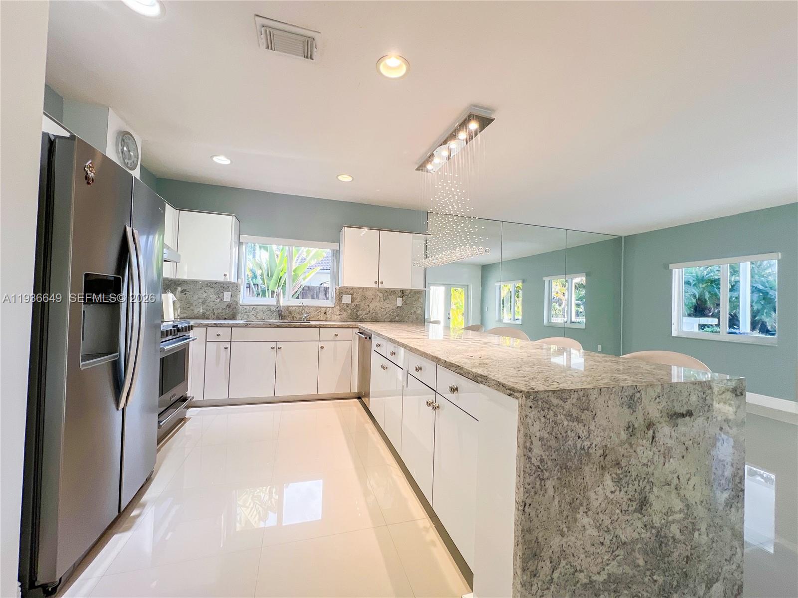 3884 Southwest 150th Court Miami, FL 33185 - Photo 15 of 45 a kitchen with granite countertop a refrigerator stove top oven and sink