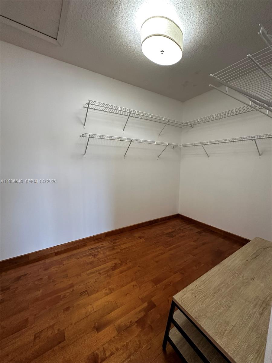 3884 Southwest 150th Court Miami, FL 33185 - Photo 25 of 45 a view of a room with wooden floor and fan