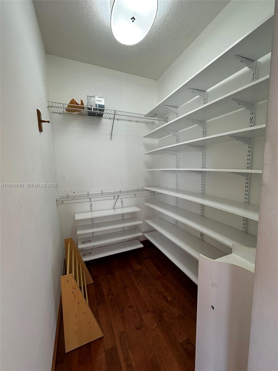 3884 Southwest 150th Court Miami, FL 33185 - Photo 26 of 45 a view of walk in closet with empty racks