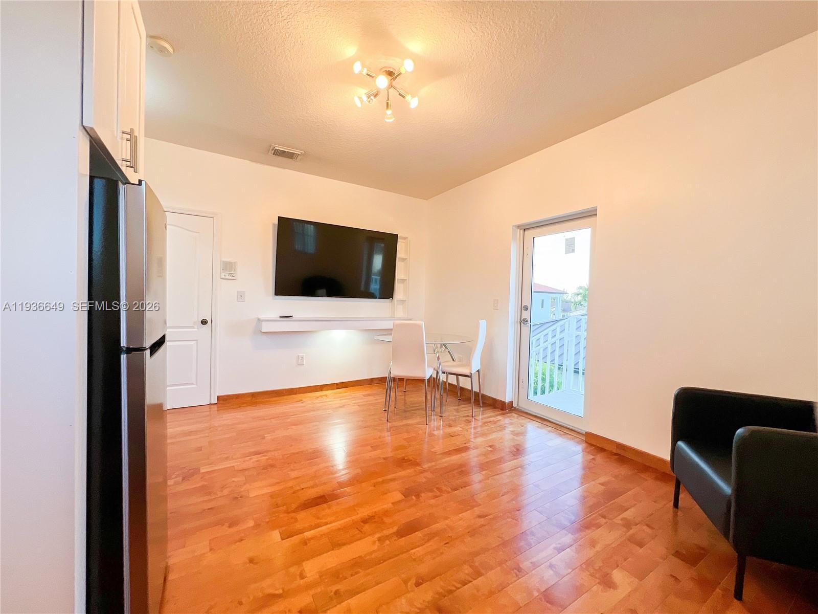 3884 Southwest 150th Court Miami, FL 33185 - Photo 27 of 45 a living room with furniture and a flat screen tv
