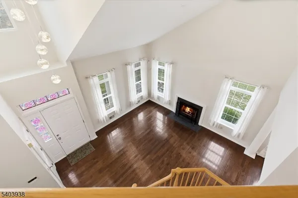 a view of a hallway with wooden floor and stairs