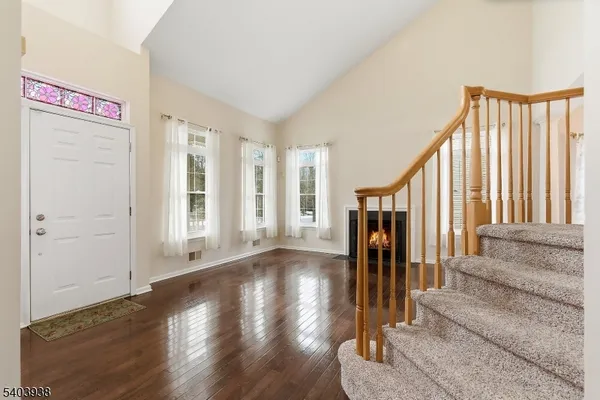 a view of entryway with wooden floor and stairs