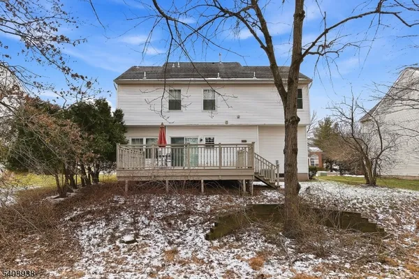 a view of a house with snow on the side of the road