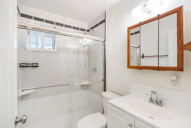 a bathroom with a sink toilet and shower