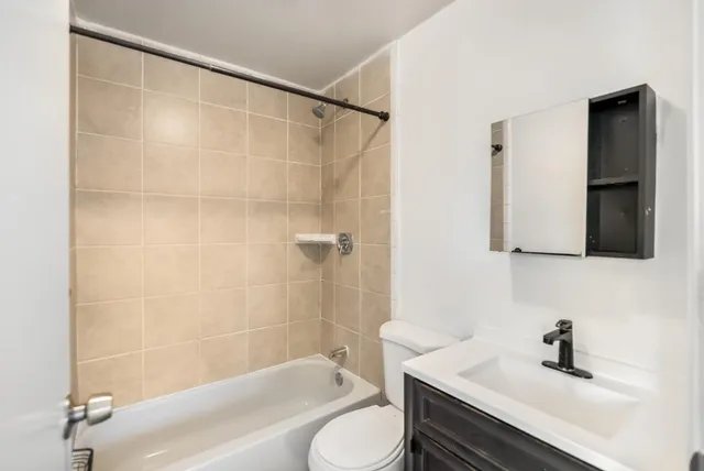 a bathroom with a sink toilet a mirror and shower