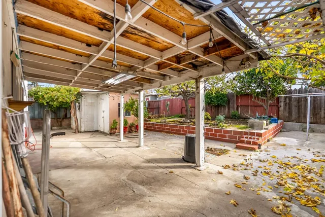 a view of a backyard with table and chairs