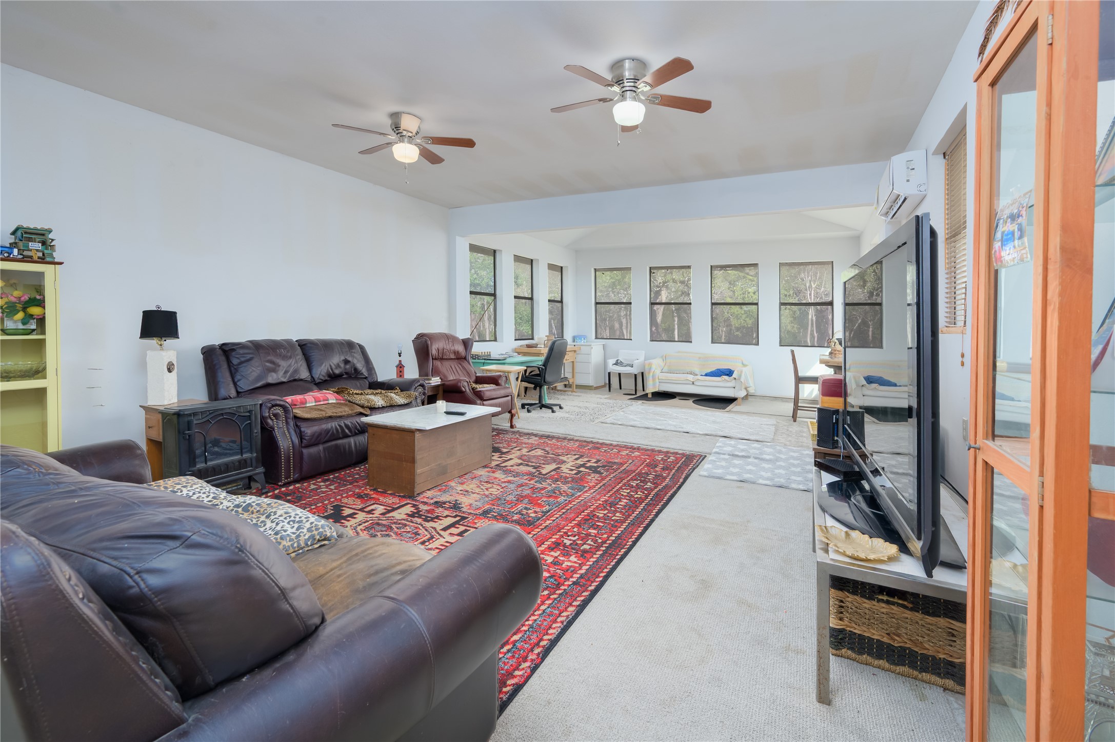 368 Lytton Lane Dale, TX 78616 - Photo 12 of 29 Living area with carpet flooring, a ceiling fan, and a wall mounted air conditioner