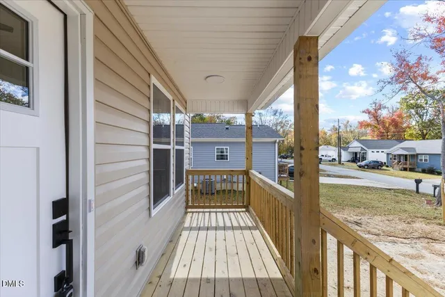 a view of a porch with a floor to ceiling window next to a yard