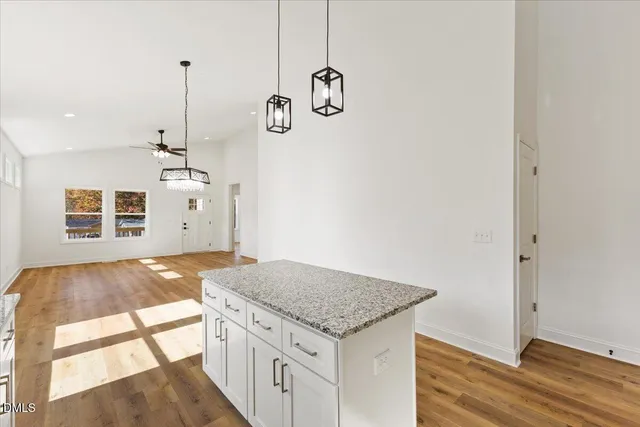 a kitchen with a granite countertop sink and stove