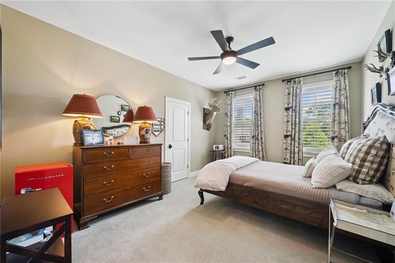 2755 Rustic Lk Terrace Cumming, GA 30041 - Photo 102 of 141 a bedroom with a bed and a chandelier