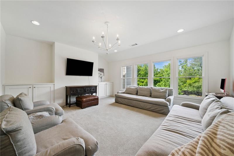 2755 Rustic Lk Terrace Cumming, GA 30041 - Photo 108 of 141 a living room with furniture a fireplace and a flat screen tv