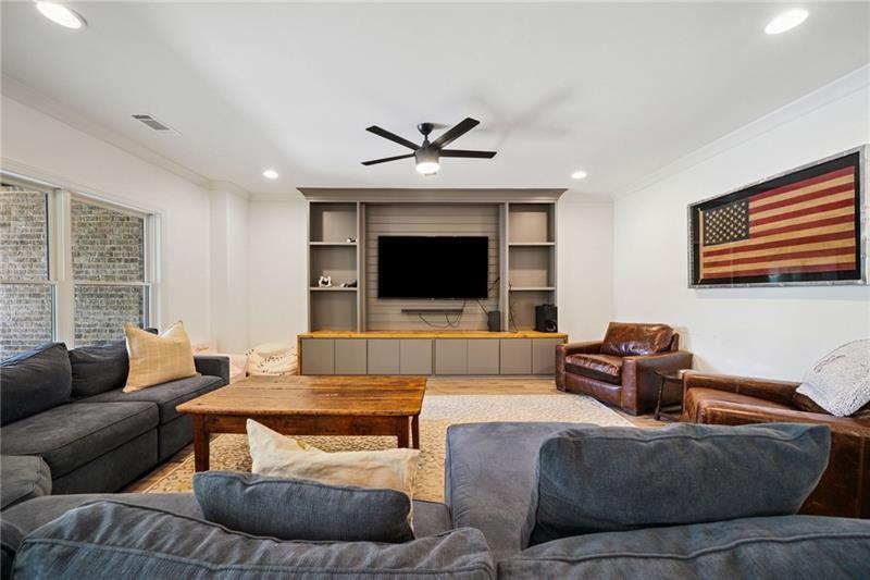 2755 Rustic Lk Terrace Cumming, GA 30041 - Photo 127 of 141 a living room with furniture and a flat screen tv