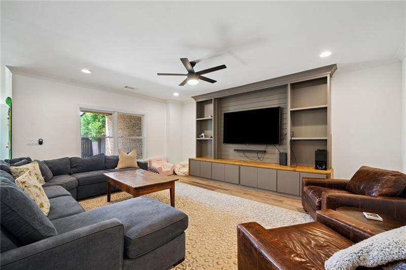 2755 Rustic Lk Terrace Cumming, GA 30041 - Photo 128 of 141 a living room with furniture and a flat screen tv
