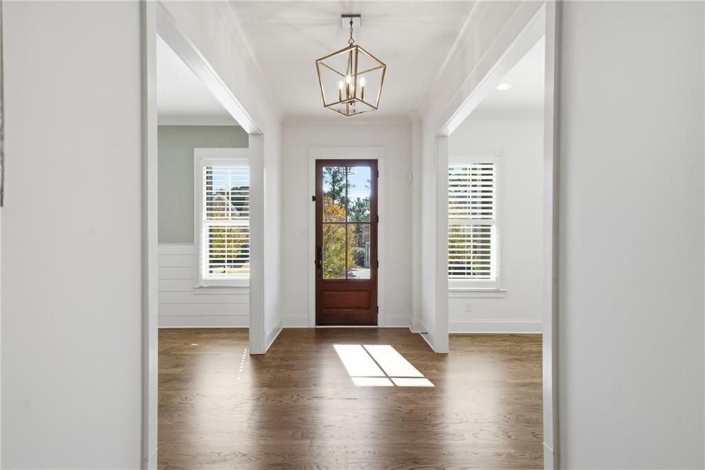 2755 Rustic Lk Terrace Cumming, GA 30041 - Photo 13 of 141 a view of an empty room with wooden floor and a window