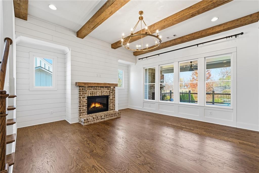 2755 Rustic Lk Terrace Cumming, GA 30041 - Photo 20 of 141 a view of an empty room with wooden floor fireplace and a window