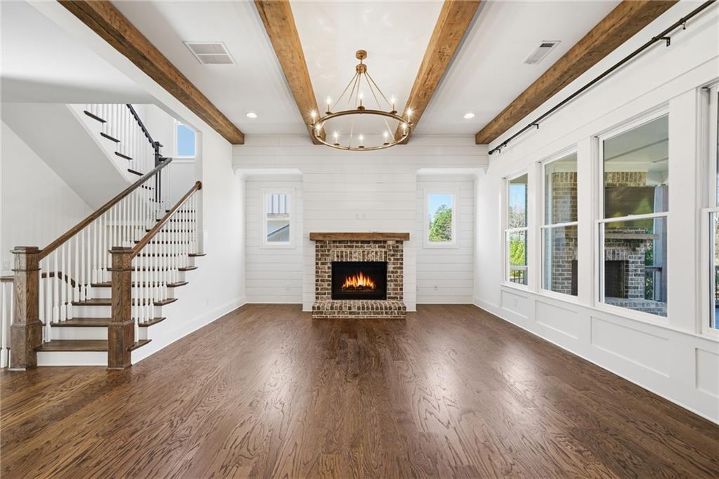 2755 Rustic Lk Terrace Cumming, GA 30041 - Photo 21 of 141 a view of an empty room with wooden floor fireplace and a window