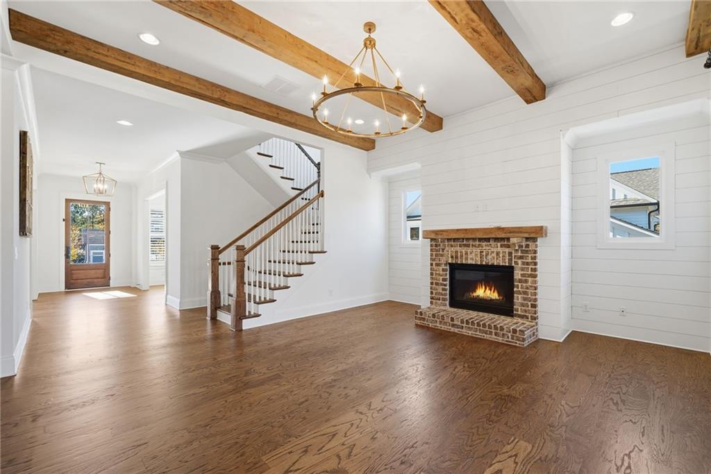 2755 Rustic Lk Terrace Cumming, GA 30041 - Photo 22 of 141 a view of an empty room with wooden floor a fireplace